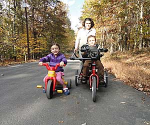 A cancer survival story continues with David riding his Rifton tricycle alongside his sister and Mom