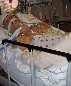 Sean Carter lying in a hospital bed following a severe car crash which left him with multiple injuries