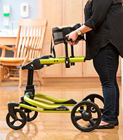 A school therapist removes the chest prompt from the Pacer gait trainer. 