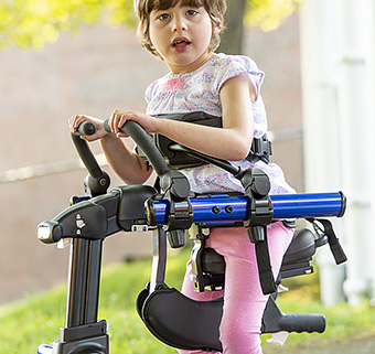 Girl using Rifton Pacer