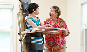 A teenager stands in a Rifton Supine Stander in a classroom.